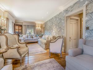 a living room with couches and chairs at Willington Lodge in Hanmer