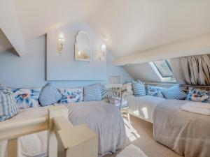 a bedroom with two beds and a couch at Willington Lodge in Hanmer