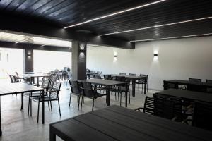 an empty dining room with tables and chairs at LOFT Hotel Solotvino in Solotvyno