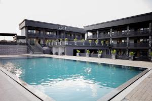 a large swimming pool in front of a building at LOFT Hotel Solotvino in Solotvyno