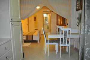 a small room with a table and chairs and a bedroom at White Coconut Studio in Christ Church