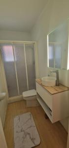 a bathroom with a sink and a mirror at Beachfront Villa in Moraira +25 photos