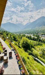 a balcony with benches and a view of a valley at ROYALE PEAKS villa sonamarg Rd 