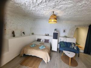 a bedroom with a bed and a chair in it at Casa Hélène in Fasnia