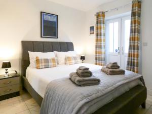 a bedroom with a bed with towels on it at Railway Cuttings in Falstone