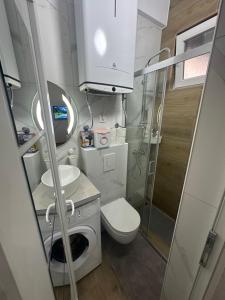a small bathroom with a toilet and a sink at AK mini studio u centru in Tivat