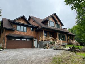 una grande casa in legno con garage di Shiraz House a North Creek