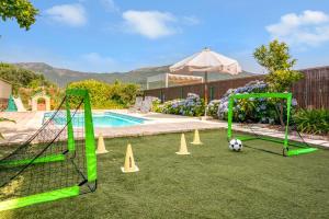 a soccer field with cones and a soccer ball at Casa Gredos- Chimenea , Setas , BBQ , Relax in Mombeltrán