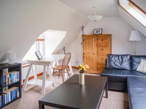 a living room with a couch and a table at The Nicolson House in Graver