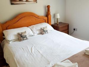 a large white bed with two pillows on it at The Red Kite - Uk31003 in Avoch