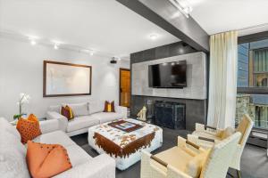 a living room with a couch and a tv at Durant Unit C2, Condo with Designer Finishes, Great Views & Location in Aspen