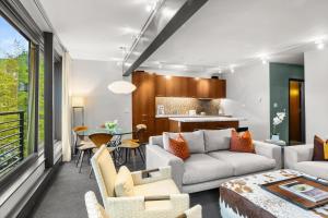 a living room with a couch and a table at Durant Unit C2, Condo with Designer Finishes, Great Views & Location in Aspen