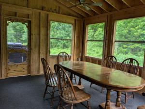 a dining room with a wooden table and chairs at Dwight Village Motel in Dwight