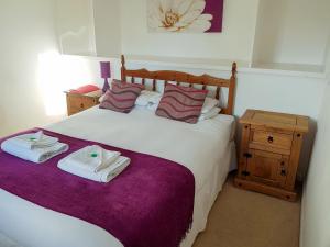 a bedroom with a bed with two towels on it at The Dolphin - Uk31004 in Avoch