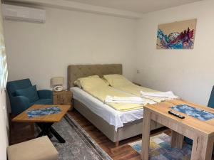 GoraždeにあるApartments Jasminのベッドとテーブルのある小さな寝室