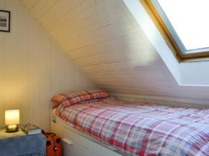 a bedroom with a bed in a attic at Shore Cottage in Arnisdale
