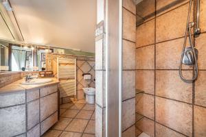 a bathroom with a toilet and a sink and a shower at Holiday home in Cala Gonone Nuoro Provinz 40363 in Cala Gonone +33 photos