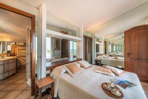 a bedroom with a large bed and a bathroom at Holiday home in Cala Gonone Nuoro Provinz 40363 in Cala Gonone