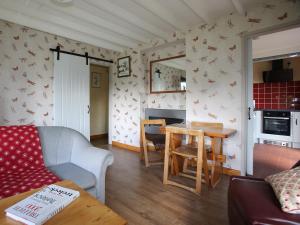 a living room with a couch and a table at The Garden House - Uk10987 in Llandogo