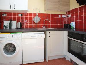 a kitchen with a washing machine and a sink at The Garden House - Uk10987 in Llandogo +8 photos