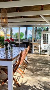 a wooden table and chairs on a patio at 7lemonshouse in Lajares