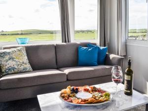 a table with a plate of food and a wine glass at The Seaview Retreat - Uk35883 in Broughton Mains