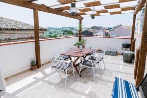 a patio with a wooden table and chairs at Villa Adriatica - Character Home, Costa dei Trabocchi in Villalfonsina