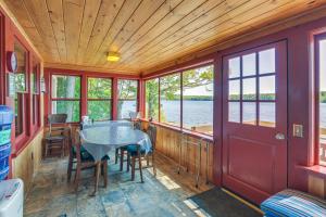 a dining area in a boat with a table and chairs at Dock, Beach, Views Rustic Green Lake Cottage in Otis