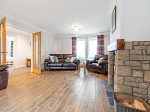 a living room with couches and a stone fireplace at Gartclach-Uk40001 in Gartmore +38 photos