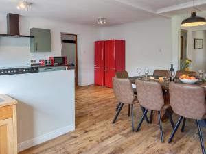 a kitchen and dining room with a table and chairs at Beech House in Torcastle