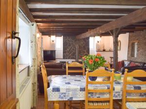 a dining room with a table with flowers on it at The Carthouse - Uk13184 in Cwm-Morgan +16 photos