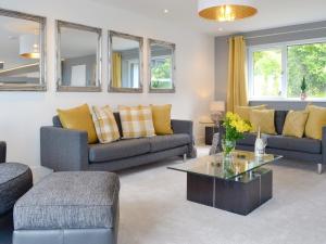 a living room with two couches and a coffee table at Hillside Retreat in Prestatyn