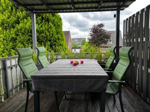 a table and four chairs on a deck with a table at Ferienwohnung Micaela in Haselünne