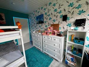a childs bedroom with a bed and a dresser at Ferienwohnung Micaela in Haselünne
