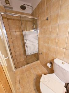 a bathroom with a shower and a toilet at Corfu Glyfada Menigos Resort 25 in Glyfada