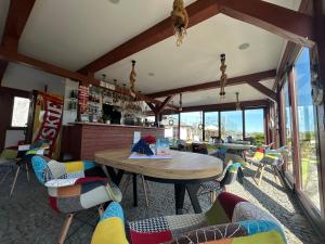 a restaurant with a table and chairs in a room at Angelika in Swarzewo