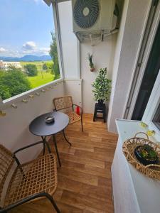 a balcony with a table and chairs and a window at Modern apartment in the center of Martin in Martin