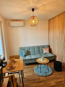 a living room with a blue couch and a table at Modern apartment in the center of Martin in Martin