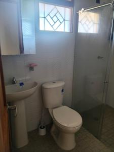 a bathroom with a toilet and a sink and a shower at Cabaña Santa Alicia in Villa de Leyva +22 photos