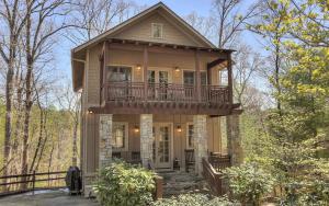 a large house with a balcony on top of it at Choctaw Lodge -Play ping pong Relax by the wood fireplace Grill in Jasper