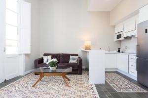 a living room with a couch and a coffee table at Palacio Miraflores in Santa Cruz de Tenerife