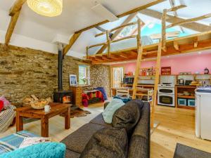 a living room with a couch and a table at 1 bed in Llandysul 85671 in Rhyd Owen