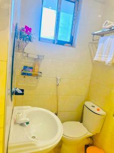 a bathroom with a white toilet and a sink at Central Beautiful & peaceful Private bedroom AC, Very fast WiFi 1 in Dar es Salaam