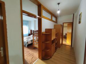 a room with a closet and a bedroom with a bed at Struga Apartment in Struga +2 photos