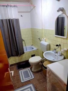 a bathroom with a toilet and a sink and a tub at Struga Apartment in Struga