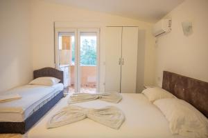 a bedroom with two beds with bows on them at Ajka apartments in Ulcinj