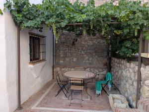 a patio with a table and chairs in a building at Molino Viejo de Salar in Salar