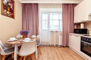 a kitchen and dining room with a table and chairs at 1-комнатная квартира Иманбаевой 2, ЖК Байконыс in Astana +13 photos