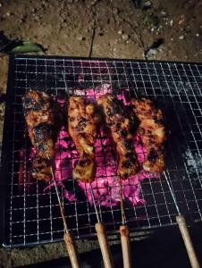 a grill with some meat on top of it at SUNSHEE COFFEE PLANTATION HOMESTAY VILLA Madikeri in Madikeri