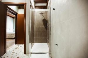 a walk in shower with a glass door in a bathroom at Casa Gotica in Castelfranco Emilia +15 photos